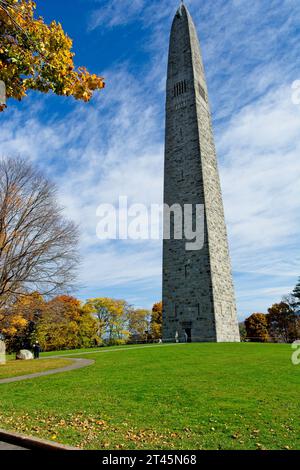 93 meter stone obelisk commemorating American Revolutionary War Battle of Bennington at monument circle,  bright  autumn trees under cloud swept sky Stock Photo