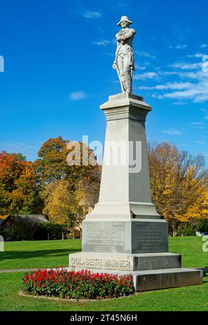 1911 granite statue of Colonel Seth Warner surrounded by bright colored trees  commemorating the 1777 Battle of Bennington —  October 2023 Stock Photo