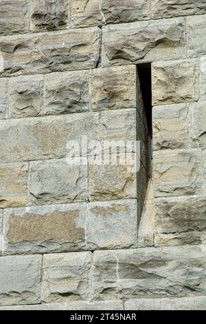 Close up of limestone block masonry obelisk with deep slotted window Stock Photo