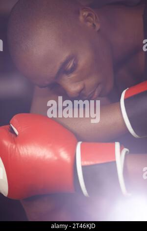 Fitness, thinking or sad boxer after loss, failure or defeat in combat or sports battle in a boxing ring. Black man, loser or frustrated African Stock Photo