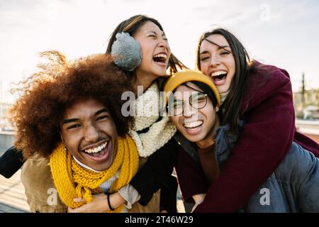 Young group of friends having fun enjoying winter vacation together. Stock Photo