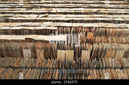 NEIJIANG, CHINA - OCTOBER 28, 2023 - An aerial photo shows a worker drying thin wood chips at a wood processing plant in Neijiang City, Sichuan Provin Stock Photo