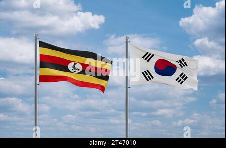 South Korea or Republic of Korea or ROK and Uganda flags waving together in the wind on blue cloudy sky, two country relationship concept Stock Photo