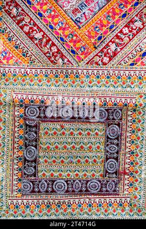 Indian patchwork carpet in Pune, Colorful Indian style rug surface close up vintage fabric is made of hand-woven cotton fabric More of this motif. Stock Photo