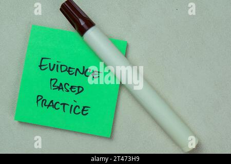 Concept of Evidence Based Practice write on sticky notes isolated on Wooden Table. Stock Photo