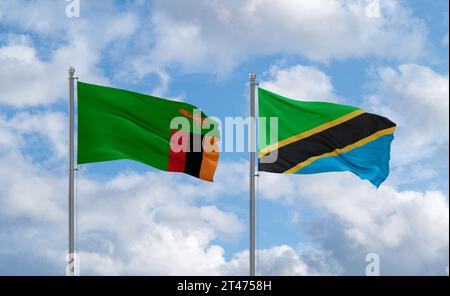 Zambia and Tanzania flags waving together in the wind on blue cloudy ...