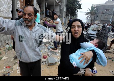 Rafah, Palestinian Territories. 29th Oct, 2023. Palestinians walk near the destroyed house belonging to the Al-Maghari family after an Israeli airstrike on Rafah, southern of the Gaza Strip. Credit: Abed Rahim Khatib/dpa/Alamy Live News Stock Photo