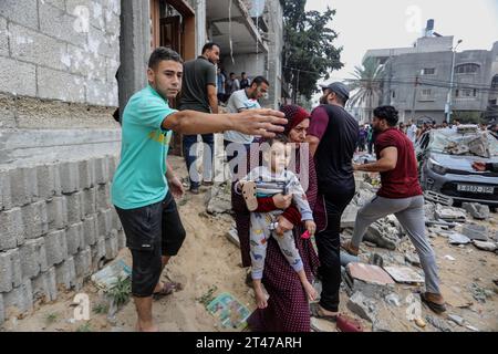 Rafah, Palestinian Territories. 29th Oct, 2023. Palestinians walk near the destroyed house belonging to the Al-Maghari family after an Israeli airstrike on Rafah, southern of the Gaza Strip. Credit: Abed Rahim Khatib/dpa/Alamy Live News Stock Photo