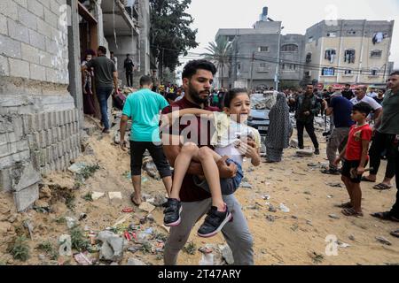 Rafah, Palestinian Territories. 29th Oct, 2023. Palestinians walk near the destroyed house belonging to the Al-Maghari family after an Israeli airstrike on Rafah, southern of the Gaza Strip. Credit: Abed Rahim Khatib/dpa/Alamy Live News Stock Photo