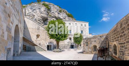 View of the upper fort courtyard with trees and the rock behind Stock Photo