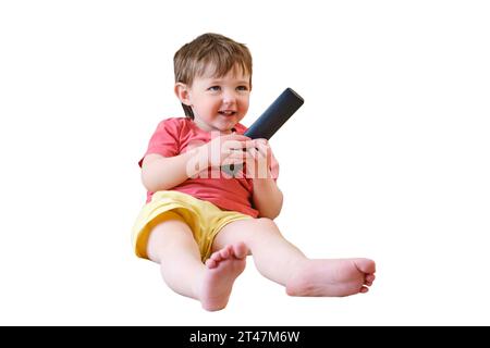 The child is watching their favorite cartoon on TV with a big smile on their face, feeling the fun and joy of being at home, isolated on white backgro Stock Photo