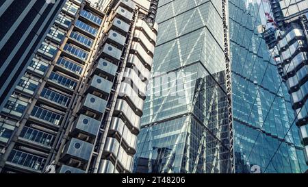 Various modern buildings in the City of London, with reflections in glass facades. Business background. Split tones. Stock Photo