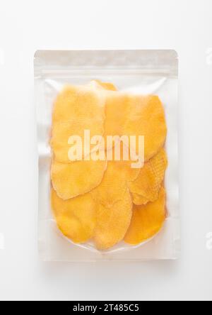 Jumbo pack of dried large sweet mango slices on white background.Top view Stock Photo