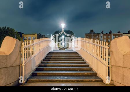 Ha'penny Bridge is a pedestrian bridge over the River Liffey in Dublin, Ireland, known for its beautiful cast-iron design and iconic status. Stock Photo
