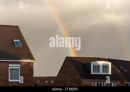rainbow over the roof of a house Stock Photo