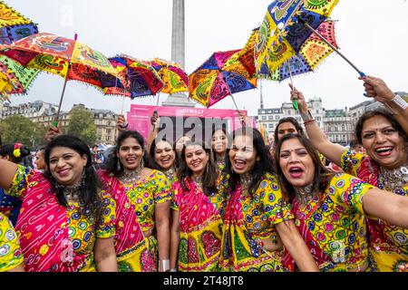 London, UK.  29 October 2023. Traditional dancers gather for the media after performing in the rain at Diwali on Trafalgar Square, an event supported by the Mayor of London.  The annual Festival of Lights celebration is celebrated by Hindus, Sikhs and Jains. Credit: Stephen Chung / Alamy Live News Stock Photo