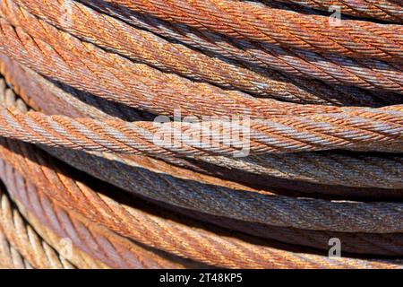Close up side lit rusty wire cable spool, side lit Stock Photo