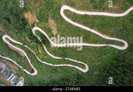 Neijiang, China. 29th Oct, 2023. NEIJIANG, CHINA - OCTOBER 28, 2023 - An aerial photo shows a car driving along a winding country road in Xinquan village, Neijiang City, Sichuan Province, China, October 28, 2023. (Photo by Costfoto/NurPhoto) Credit: NurPhoto SRL/Alamy Live News Stock Photo