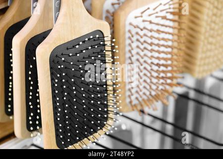 Massage combs hang on a display window in a market, close-up Stock Photo