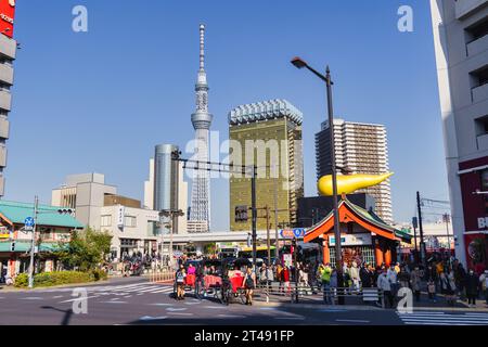 Tokyo, Japan - April 09, 2023: street view from Asakusa to the Sumida skyline. To see are the famous Tokyo skytree and the Asahi Beer hall, with unide Stock Photo