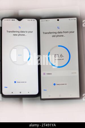 Two android phones kept close to each other during first time file transfer or installation process Stock Photo
