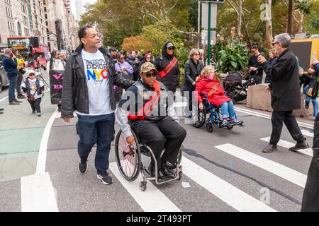 People with disabilities and their supporters march from Madison Square Park in New York for the Disability Pride Parade on Sunday, October 22, 2023 celebrating the Americans With Disabilities Act (ADA).  The ADA ensured accessibility to the disabled and removed barriers to employment, transportation, public accommodations, public services and telecommunications. (© Richard B. Levine) Stock Photo