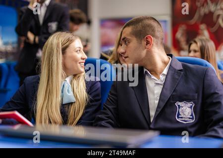 Students talking to their classmate in the back Stock Photo