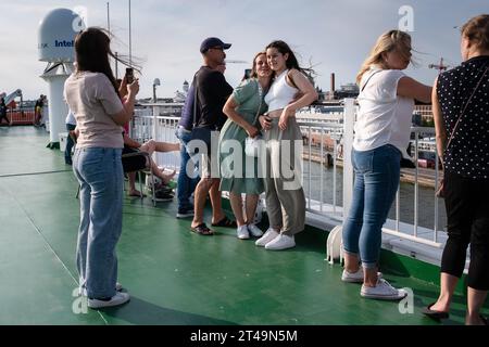 Passengers taking pictures on a cruise ferry ship in the central Port of Helsinki travelling on a Baltic Sea cruise between Finland, Åland and Sweden Stock Photo