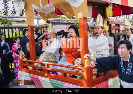 Tokyo, Japan - April 09, 2023: parade at a Matsuri at the Senso-Ji Temple in Asakusa, with unidentified people. Matsuri are traditional Japanese festi Stock Photo