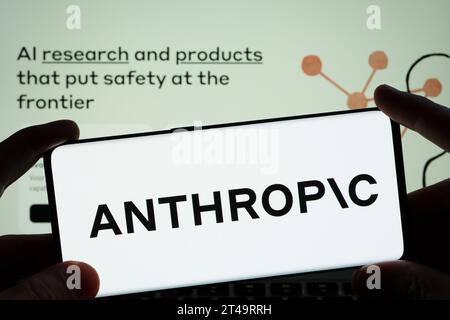 Anthropic AI research company logo seen on the smartphone and blurred company website seen at the background.  Stafford, United Kingdom, October 29, 2 Stock Photo