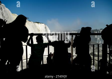 Iguaçu National Park, Brazil- July 26, 2022: Silhouettes of tourists observing the Santa Maria waterfall from a viewpoint Stock Photo