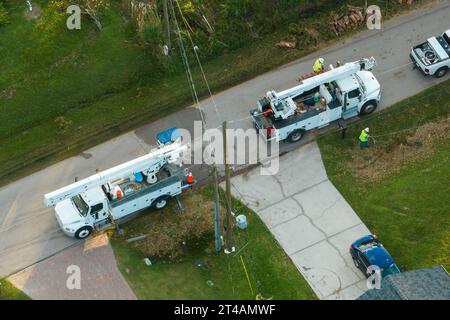 Aerial view of electrician workers repairing damaged power lines after hurricane Ian in Florida suburban area Stock Photo