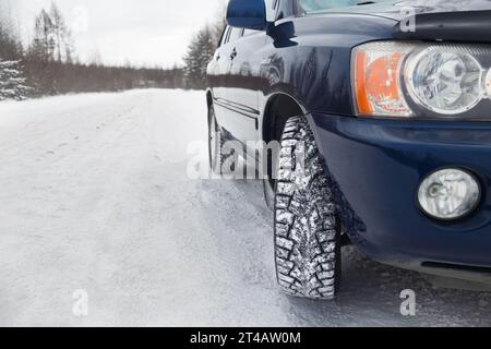 Car with winter tires on a winter road Stock Photo