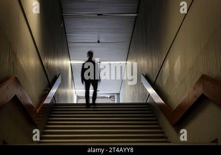 Bochum, Germany. 10th Oct, 2023. ILLUSTRATION: A man walks through the corridors of the Humanities building at the Ruhr University in Bochum. According to research by the legend researcher D. Sondermann, the building is said to be haunted. The 'Eternal Student' is haunting the brittle concrete architecture. (To dpa: 'The Eternal Student' of Bochum') Credit: Oliver Berg/dpa/Alamy Live News Stock Photo