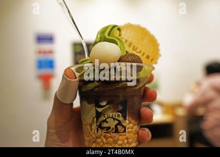 Close up take away plastic cup of Japanese tradition Matcha green tea ice cream Stock Photo