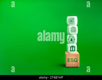 Environmental, social, and corporate governance (ESG), environment sustainable for save the earthconcept. Acronym text 'ESG' on wood cube and icons on Stock Photo