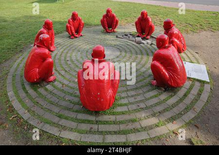 Sculpture Meeting by Wang Shugang 2013, sculpture group, red, figures, circle, sitting, men, Chinese, Chinese monks, kneeling, Schoenleinplatz Stock Photo