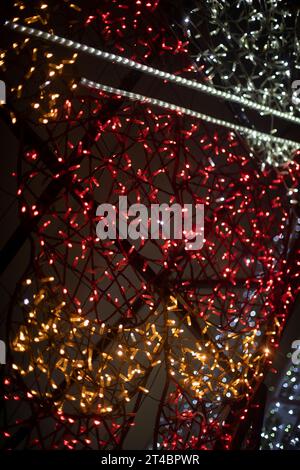 Texture made of LEDs. Garlands in dark. Bright light bulbs on black background. Decoration in details. Stock Photo