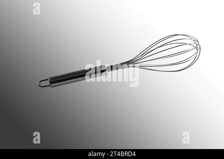 Whisk for whipping. Close-up. Isolated on a gray background. Stock Photo