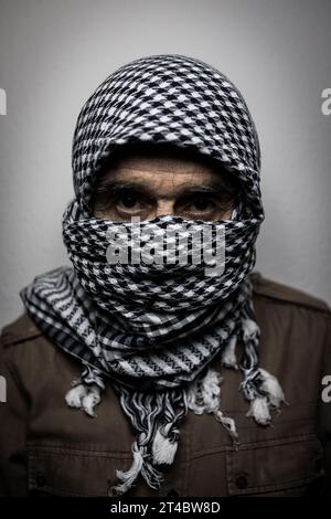 Portrait of military man wearing Palestinian headscarf or shemagh ...
