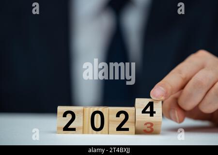 Flipping of 2023 to 2024 on flip block for preparation new year change and start new business target strategy concept. Stock Photo