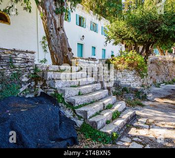 Quiet corner of the pretty little fishing harbour of Kouloura on the north-east coast of Corfu in the Ionian Islands of Greece Stock Photo