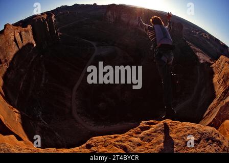 man base jumping off cliff, Utah (Fisheye). Stock Photo