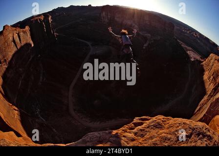 A man base jumping off the Tombstone cliff outside of Moab, Utah, USA. Stock Photo