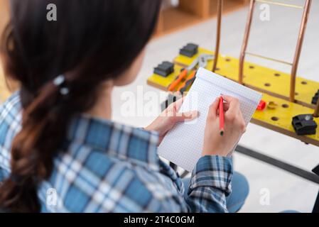 happy female worker writing down notes Stock Photo