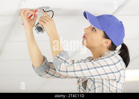 pretty female cctv installing cctv Stock Photo