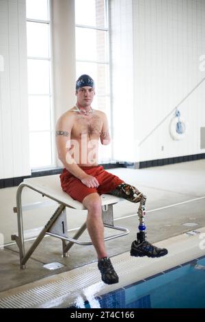 An Iraq War vetern begins rehab in a swimming pool after losing his left arm and left leg. Stock Photo