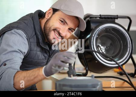 young male technician checking appliance Stock Photo