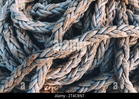 Old worn frayed ship ropes as background, selective focus Stock Photo