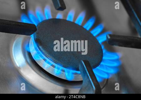Closeup of the blue flames from a domestic gas stove in a kitchen. Gas stove with burning flames of natural gas. Stock Photo